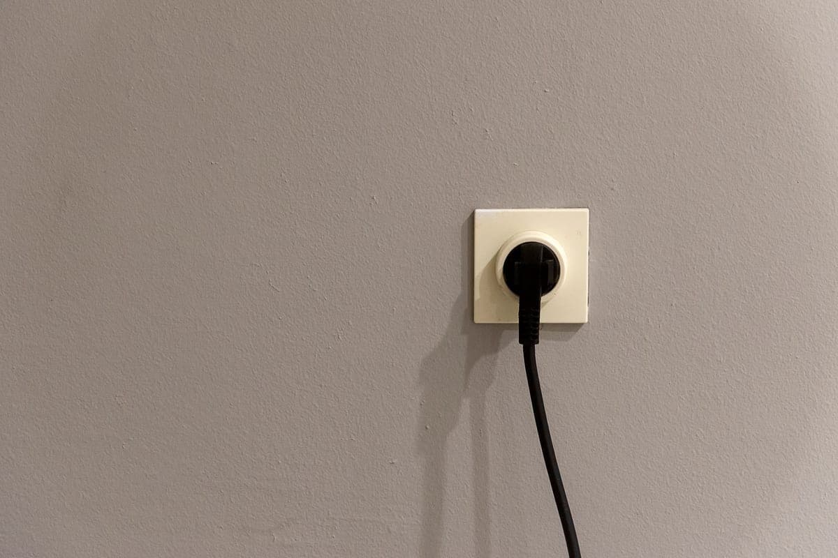 A power plug inserted into a wall socket