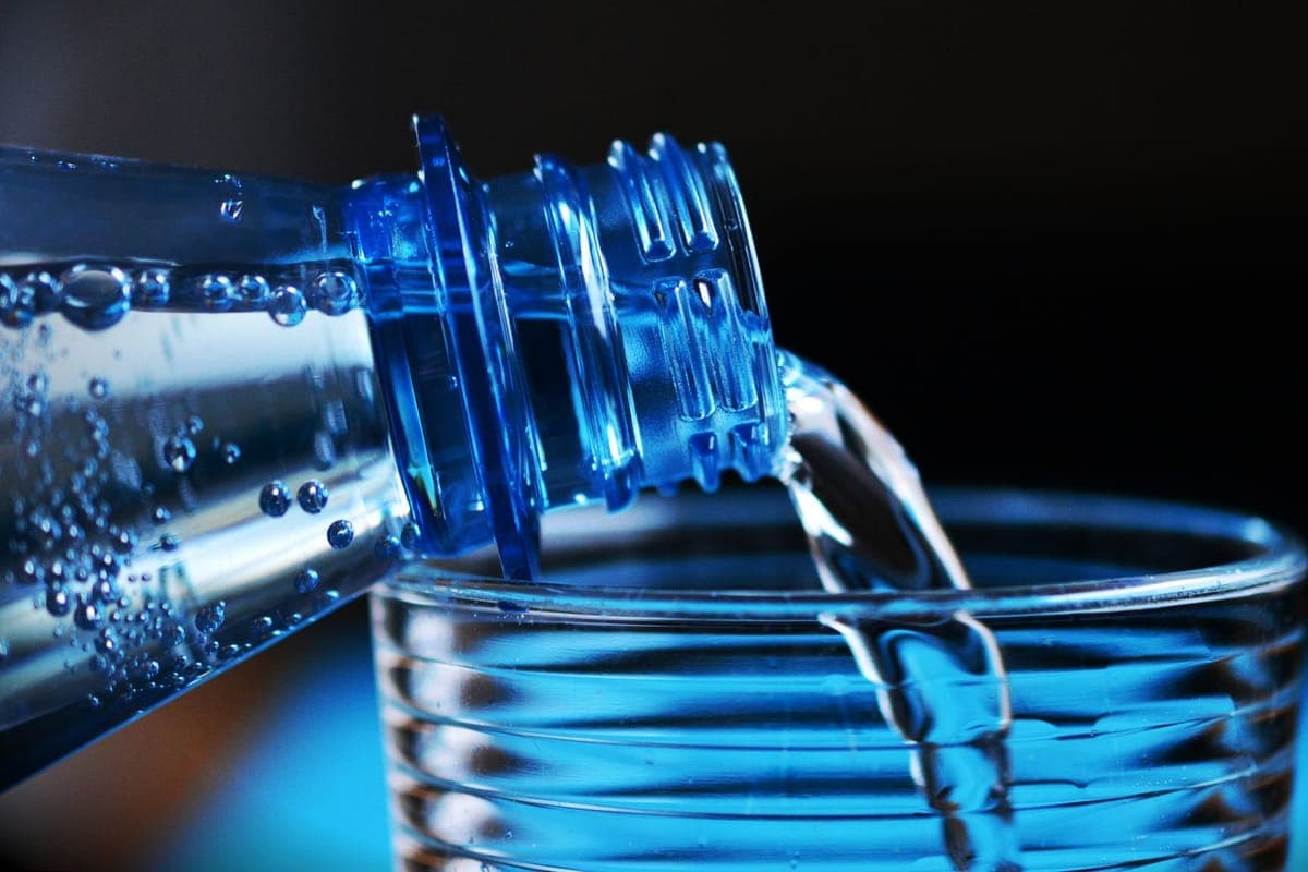 Water being poured from a bottle into a glass
