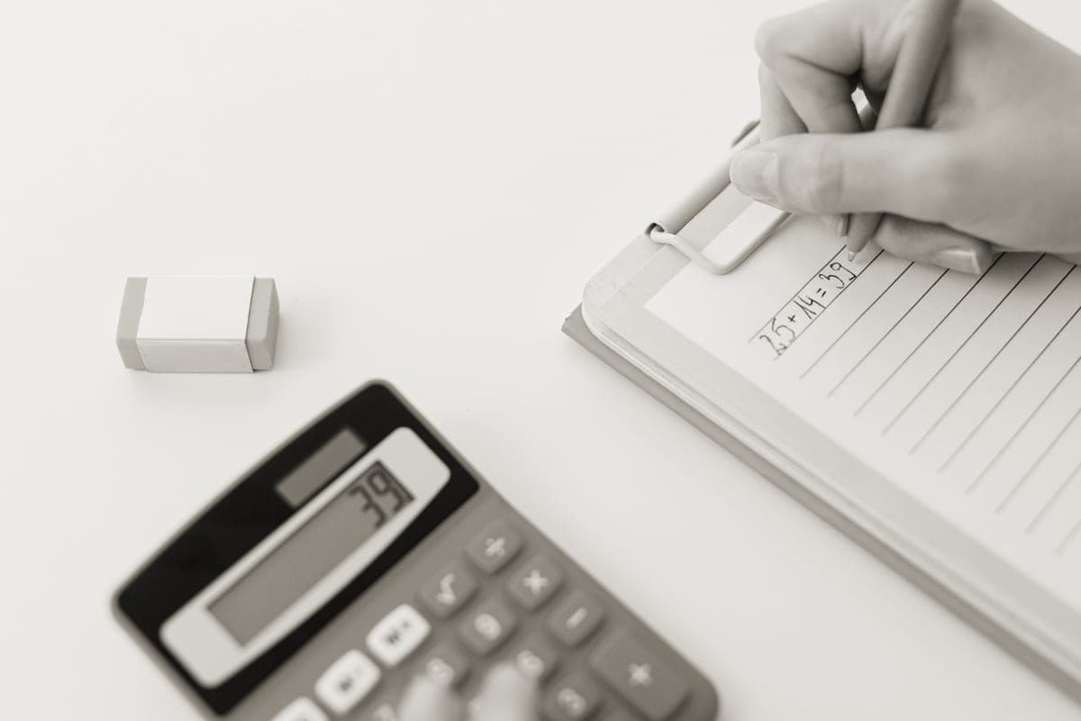 A notebook and calculator on a desk, used for working out equipment sizing